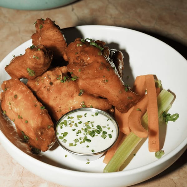 Dodo Bird Kitchen and Cocktails' chicken wings with ranch dressing, carrots, and celery sticks.